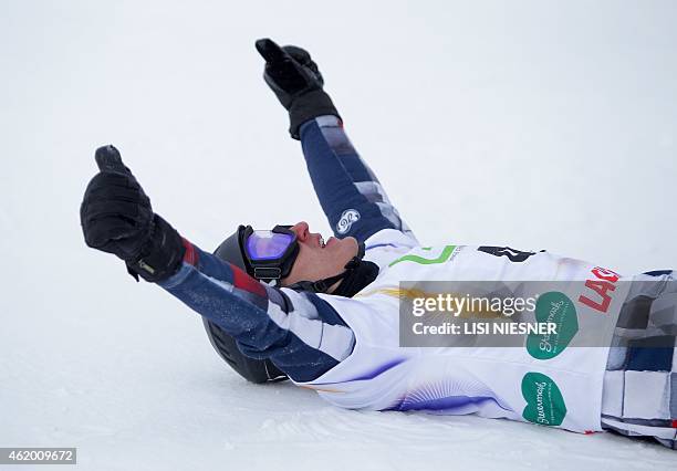 First placed Russia's Andrey Sobolev reacts after the Men's Snowboard Parallel Giant slalom finals at FIS Freestyle and Snowboarding World Ski...