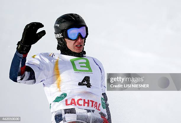 First placed Russia's Andrey Sobolev reacts after the Men's Snowboard Parallel Giant Slalom Finals of FIS Freestyle and Snowboarding World Ski...