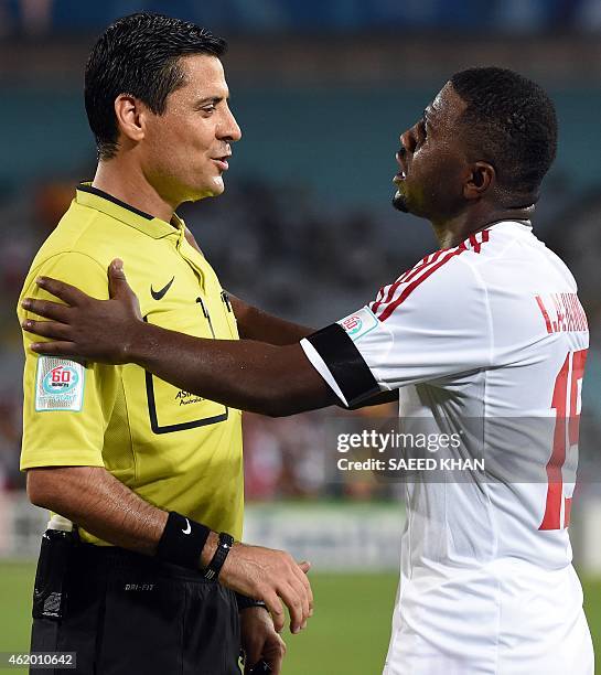 Ismail Al Hammadi of the United Arab Emirates talks to referee Alireza Faghani of Iran during the quarter-final football match between Japan and UAE...