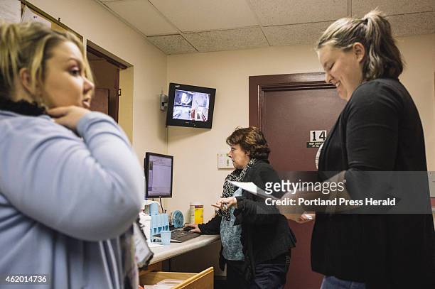 Courtney Clark, left, Vanessa Leavitt, center, and Deanna Boisvert speak together before patients come in for their methadone dosages at CAP Quality...