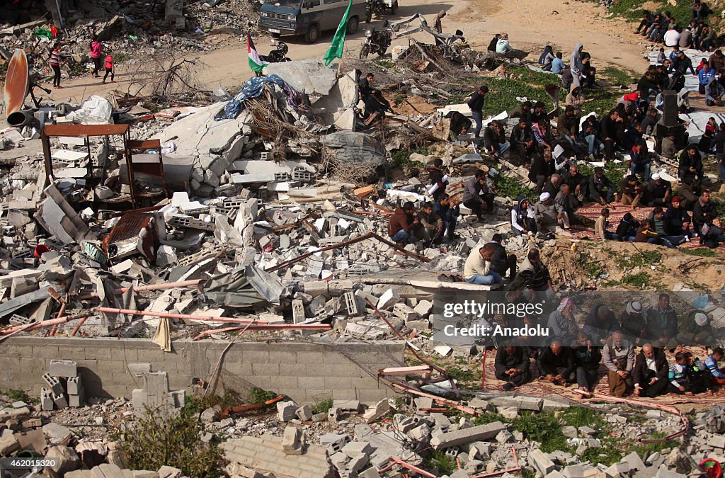 Palestinians performing Friday prayer among ruins in Johr al-Deek