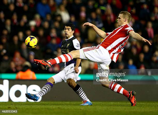 Luis Suarez of Liverpool pressures Ryan Shawcross of Stoke City to score their second goal during the Barclays Premier League match between Stoke...