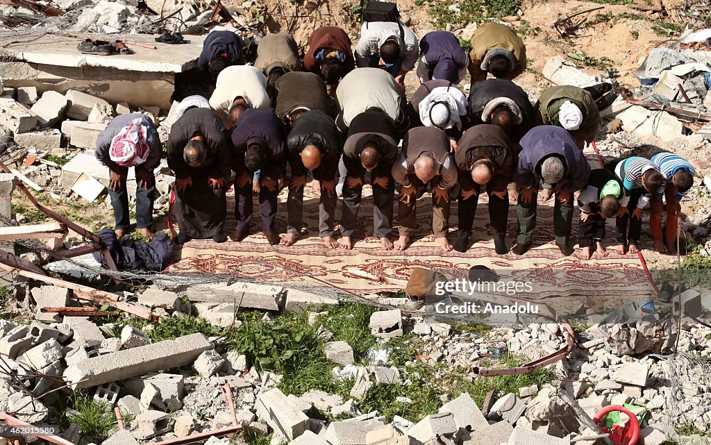 Palestinians performing Friday prayer among ruins in Johr al-Deek