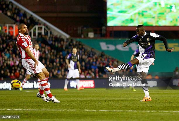 Aly Cissokho of Liverpool shoots as his shot deflects in off Ryan Shawcross of Stoke City for an own goal for their first goal during the Barclays...