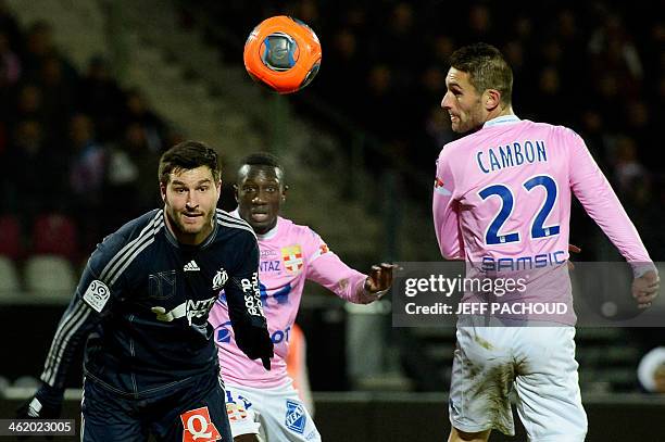 Marseille's French forward Andre-Pierre Gignac vies with Evian's Congolese defender Cedric Mongongu and Evian's French midfielder Cédric Cambon...