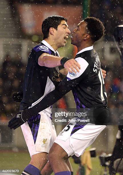 Luis Suarez of Liverpool celebrates after scoring his second goal with Daniel Sturridge during the Barclays Premier Leauge match between Stoke City...