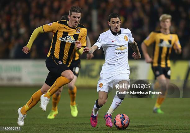 Angel di Maria of Manchester United in action with Liam Hughes of Cambridge United during the FA Cup Fourth Round match between Cambridge United and...