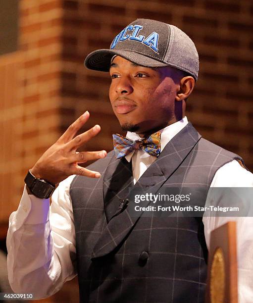 Wide receiver Ryan Newsome indicates he will spend the next four years at UCLA during a gathering in the Aledo High School Auditorium on Friday, Jan....