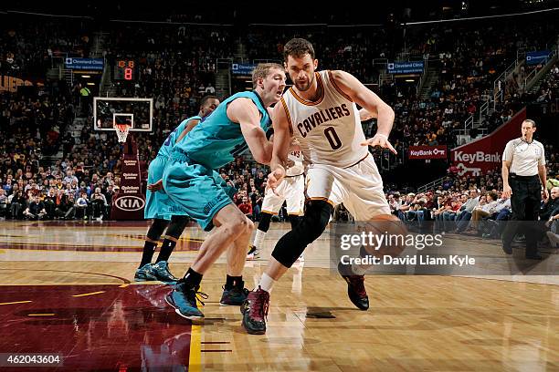 Kevin Love of the Cleveland Cavaliers drives against Cody Zeller of the Charlotte Hornets at The Quicken Loans Arena on January 23, 2015 in...