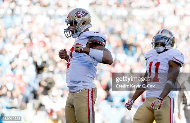 Colin Kaepernick of the San Francisco 49ers celebrates after a touchdown in the third quarter against the Carolina Panthers during the NFC Divisional...