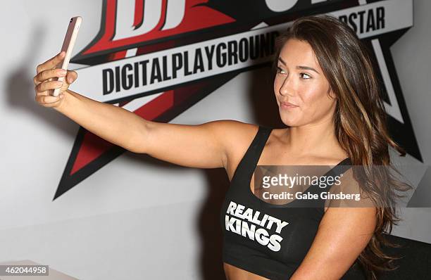 Adult film actress Eva Lovia takes a photo of herself during the 2015 AVN Adult Entertainment Expo at the Hard Rock Hotel & Casino on January 23,...