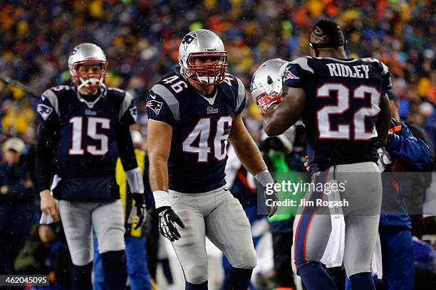 Stevan Ridley of the New England Patriots celebrates with teammates James Develin and Ryan Mallett after scoring a two point conversion in the third...