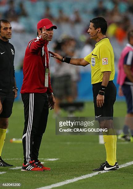 Mahdi Ali , coach of United Arab Emirates and the referee speak during the quarter-final football match between Japan and UAE at the AFC Asian Cup in...