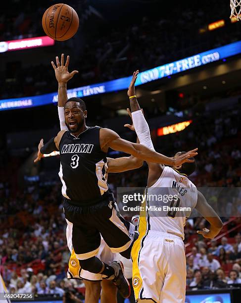Dwyane Wade of the Miami Heat is fouled by C.J. Miles of the Indiana Pacers during a game at American Airlines Arena on January 23, 2015 in Miami,...