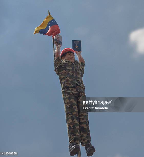 Doll with figure of Venezuela's late President Hugo Chavez is held up in the air during the "March of the Undefeated" commemorating the 57th...