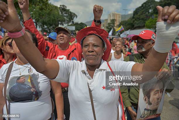 Woman cheers as she attends the "March of the Undefeated" commemorating the 57th anniversary of the overthrow of the Marco Perez Jimenez dictatorship...