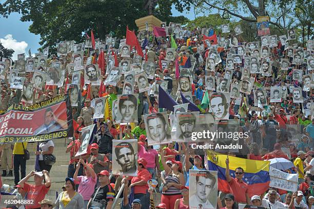 Supporters of Venezuelan President Nicolas Maduro listen as he gives a speech during the "March of the Undefeated" commemorating the 57th anniversary...