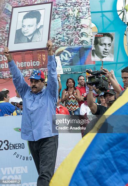 Venezuelan President Nicolas Maduro holds up a picture of Fabricio Ojeda during the "March of the Undefeated" commemorating the 57th anniversary of...