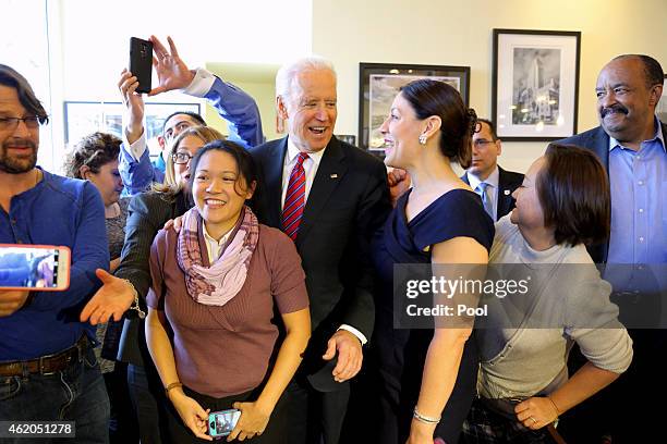 Vice President Joe Biden takes photos with patrons as he meets with health care officials at the Homegirl Cafe on January 23, 2015 in downtown Los...