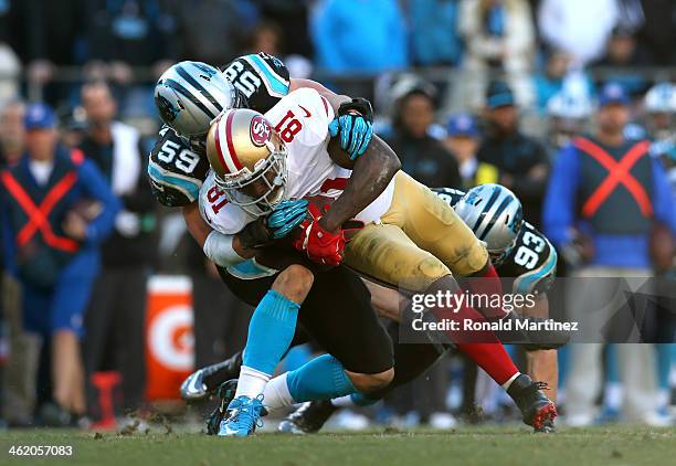 Anquan Boldin of the San Francisco 49ers is tackled after a catch by Luke Kuechly and Chase Blackburn of the Carolina Panthers in the fourth quarter...