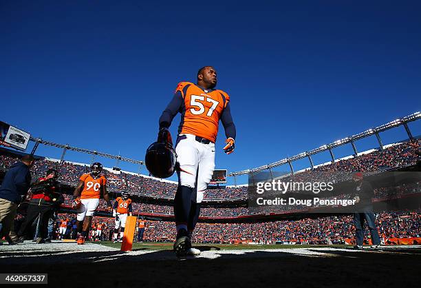 Jeremy Mincey of the Denver Broncos walks off the field after warming up prior to their AFC Divisional Playoff Game against the San Diego Chargers at...