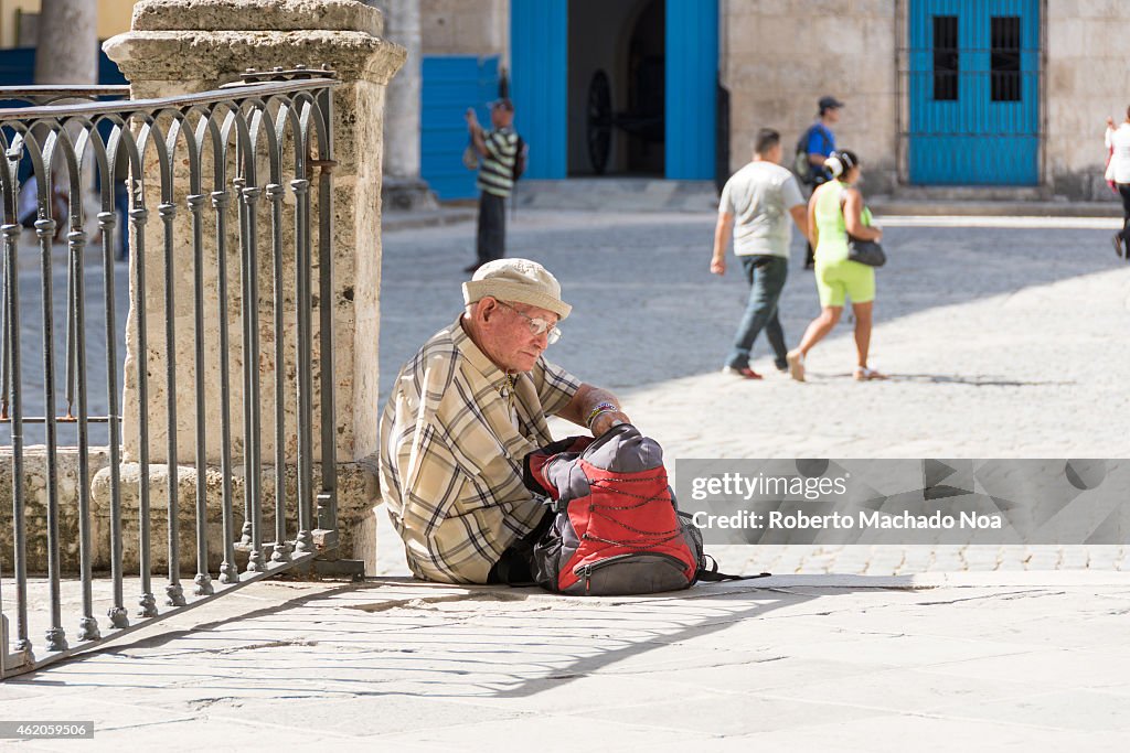 Old disable senior man in front of the Havana Cathedral