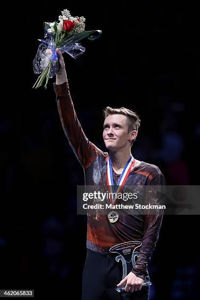 Jeremy Abbott celebrates on the medals podium after winning the men's competition during the Prudential U.S. Figure Skating Championships at TD...