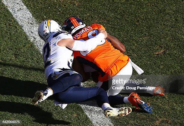 Demaryius Thomas of the Denver Broncos scores a first quarter touchdown against the defense of Eric Weddle of the San Diego Chargers during the AFC...