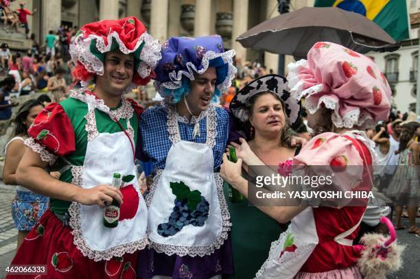 Disguised men enjoy during the performance of Bloco da Ansiedade, a carnival group, on a street in Rio de Janeiro, Brazil on January 12, 2014. AFP...