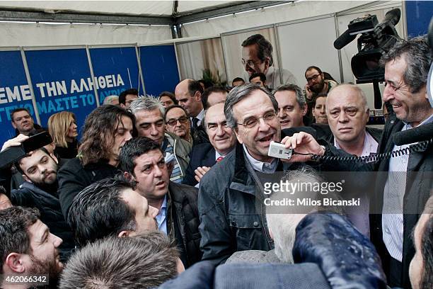 Greece's Prime Minister Antonis Samaras with his supporters outside an election kiosk of his conservative New Democracy party on January 24, 2015 in...