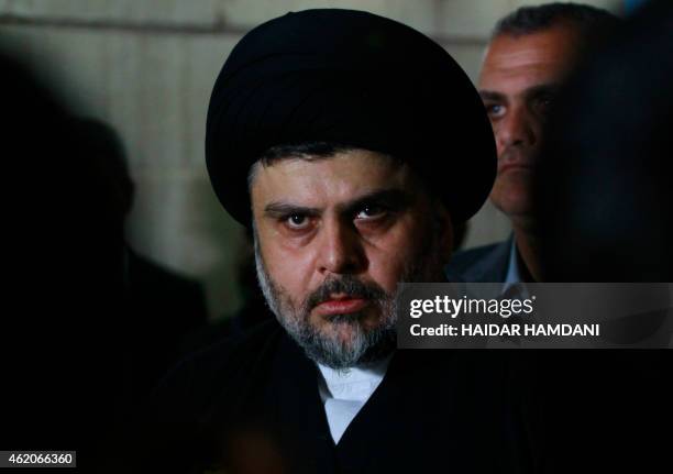 Iraqi Shiite cleric Moqtada al-Sadr looks on during a meeting to discuss economic and security issues held at Iraqi Shiite Muslim leader Ammar...