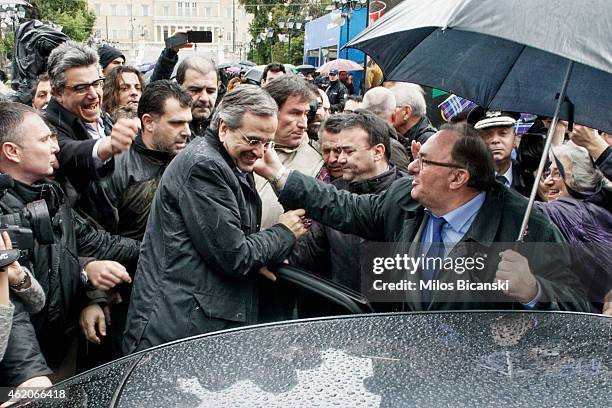 Greece's Prime Minister Antonis Samaras with his supporters outside an election kiosk of his conservative New Democracy party on January 24, 2015 in...