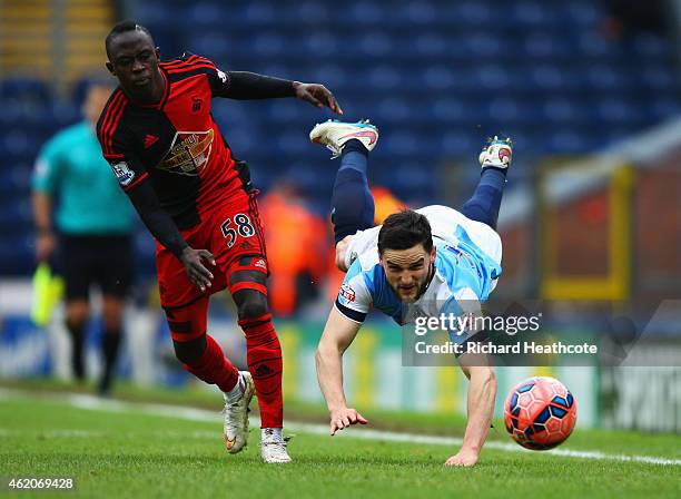 Craig Conway of Blackburn Rovers is challenged by Modou Barrow of Swansea City during the FA Cup Fourth Round match between Blackburn Rovers and...