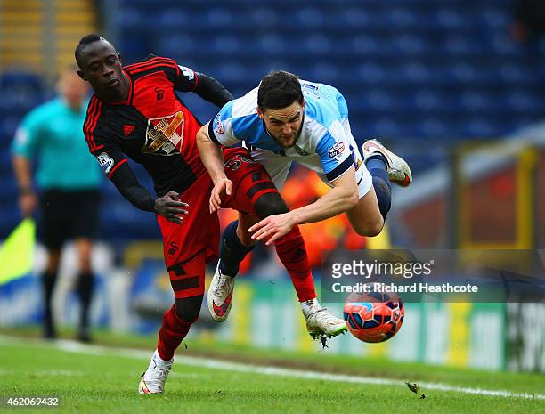Craig Conway of Blackburn Rovers is challenged by Modou Barrow of Swansea City during the FA Cup Fourth Round match between Blackburn Rovers and...