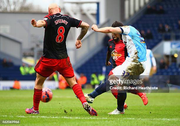 Craig Conway of Blackburn Rovers shoots past Jonjo Shelvey of Swansea City to score their third goal during the FA Cup Fourth Round match between...