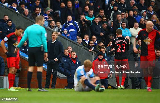 Garry Monk manager of Swansea City looks on as Gylfi Sigurdsson of Swansea City is sent off for a tackle on Chris Taylor of Blackburn Rovers during...