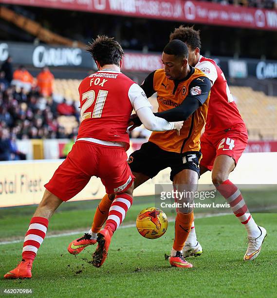 Rajiv van La Parra of Wolverhampton Wanderers is tackled by Morgan Fox and Jordan Cousins of Charlton Athletic during the Sky Bet Championship match...