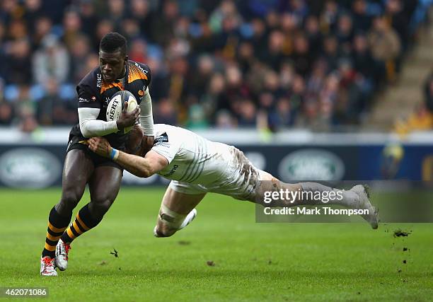 Christian Wade of Wasps is tackled by Jamie Heaslip of Leinster during the European Rugby Champions Cup game between Wasps and Leinster Rugby at The...