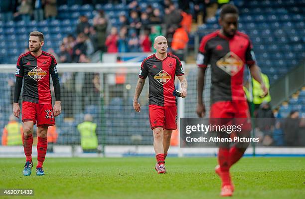 Angel Rangel of Swansea City Jonjo Shelvey of Swansea City and Nathan Dyer of Swansea leave the field at the end of the match during the FA Cup...