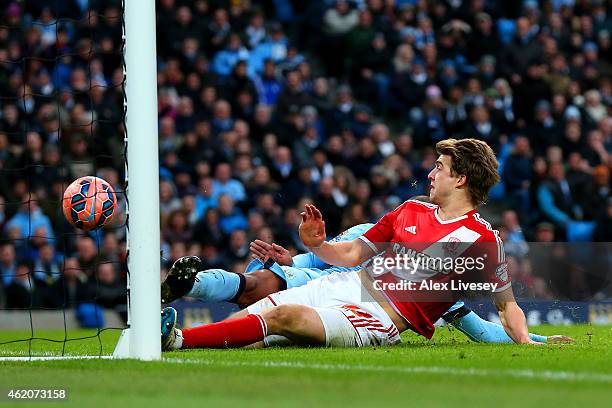 Fernando of Manchester City slides in and attempts to clear the ball but it rebounds off Patrick Bamford of Middlesbrough and crosses the goal line...