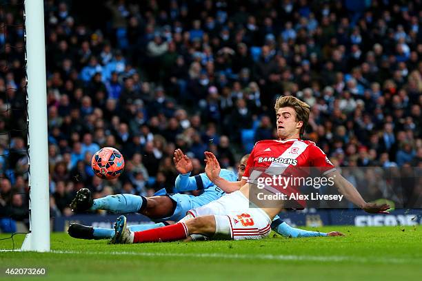 Fernando of Manchester City slides in and attempts to clear the ball but it rebounds off Patrick Bamford of Middlesbrough and crosses the goal line...