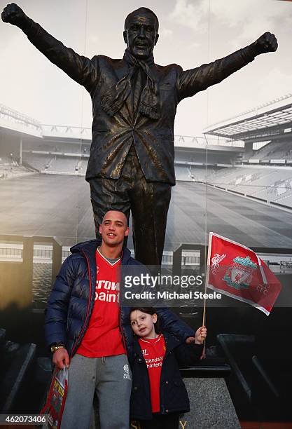 Supporters of Liverpool pose for a photograph in front of the Bill Shankly statue ahead of the FA Cup fourth round match between Liverpool and Bolton...