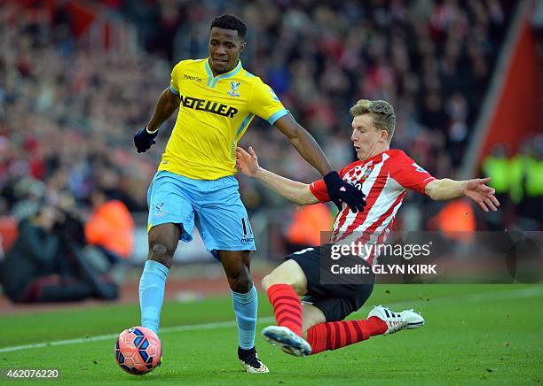 Crystal Palace's English midfielder Wilfried Zaha vies with Southampton's English defender Matt Targett during the FA Cup fourth round football match...