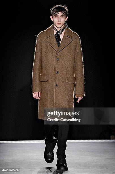 Model walks the runway at the Wooyoungmi Autumn Winter 2015 fashion show during Paris Menswear Fashion Week on January 24, 2015 in Paris, France.