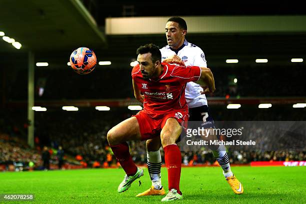 Jose Enrique of Liverpool shields the ball from Liam Feeney of Bolton Wanderers during the FA Cup Fourth Round match between Liverpool and Bolton...