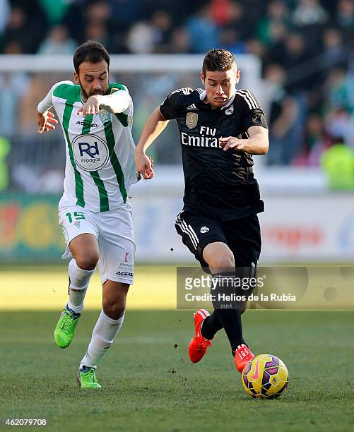 James Rodriguez of Real Madrid and Deivid Rodriguez of Cordoba cf compete for the ball during the liga match between Cordoba CF and Real Madrid CF at...