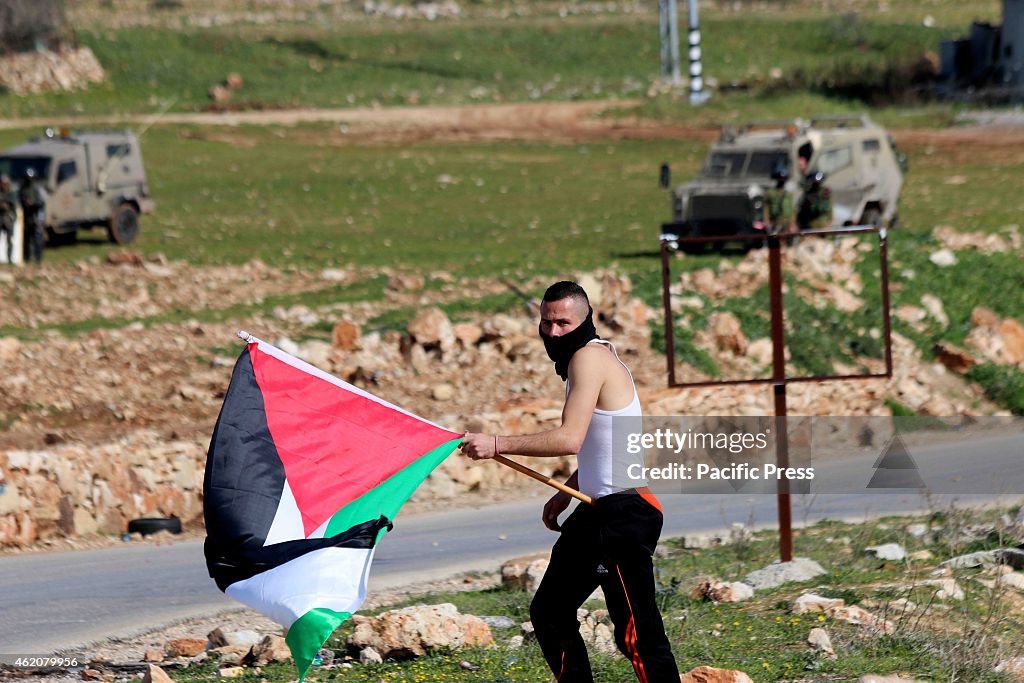 A Palestinian youth marches with a Palestinian flag as an...