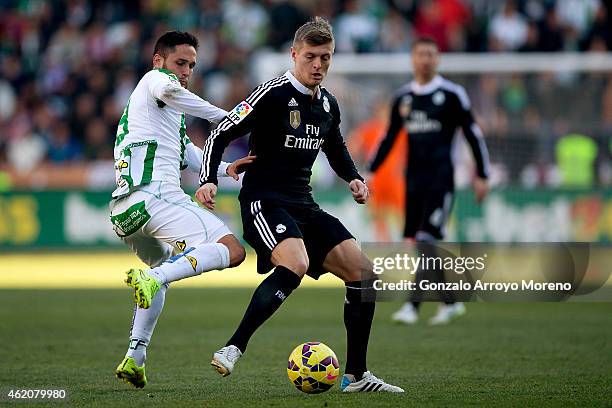 Toni Kroos of Real Madrid CF competes for the ball with Forin Andone of Cordoba CF during the La Liga match between Cordoba CF and Real Madrid CF at...