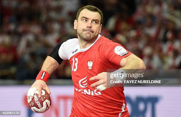 Poland's Bartosz Jurecki passes the ball during the 24th Men's Handball World Championships preliminary round Group D match between Russia and...