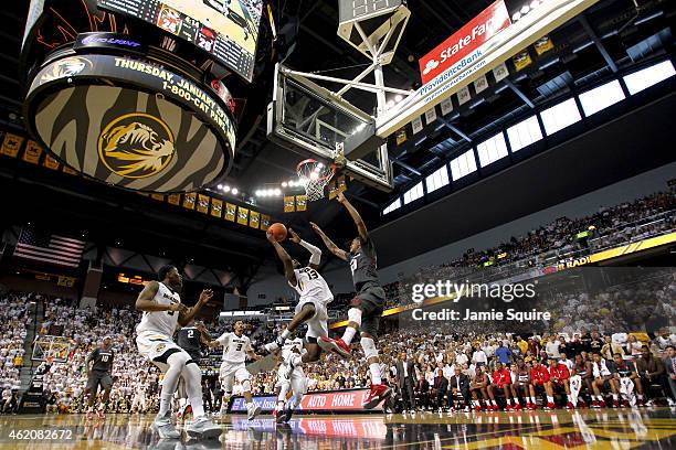 Montaque Gill-Caesar of the Missouri Tigers shoots while Rashad Madden and Alandise Harris of the Arkansas Razorbacks defend during the game at...